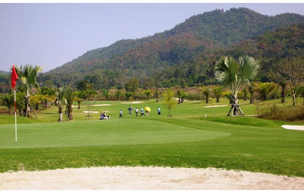 golfers at happy city golf resort, chiang rai, thailand