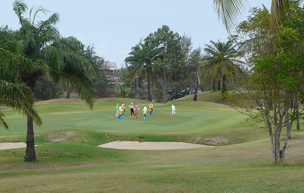 caddies on green crystal bay golf club, pattaya, thailand